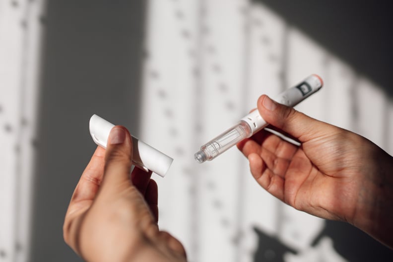 Woman holding a GLP-1 injection pen